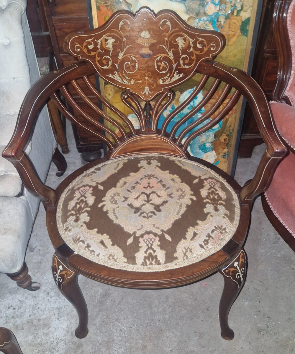 An Edwardian mahogany tub chair featuring floral marquetry inlay on the back splat, sweeping armrests, and an upholstered seat. View VII