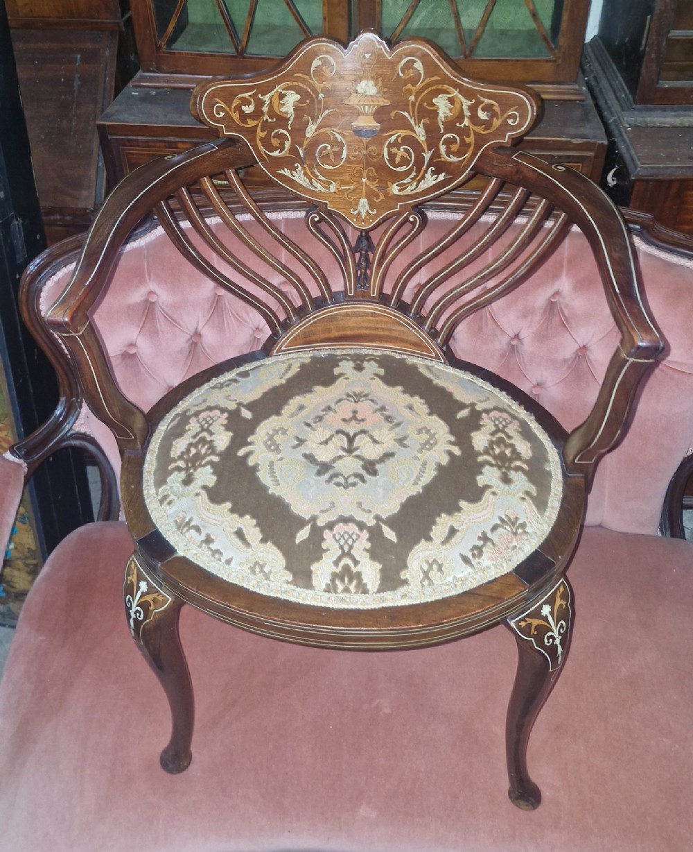 An Edwardian mahogany tub chair featuring floral marquetry inlay on the back splat, sweeping armrests, and an upholstered seat. View VIII