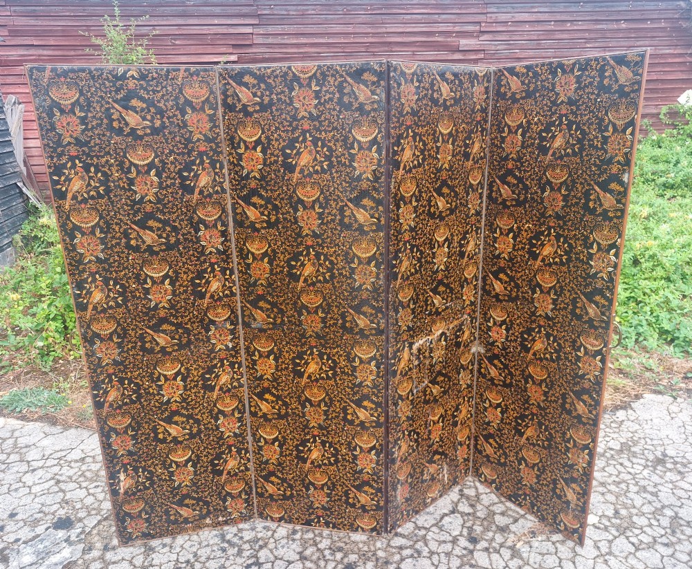 A late Victorian four-panel folding screen made of painted canvas featuring repeating golden bird and floral patterns on a dark black background. View III