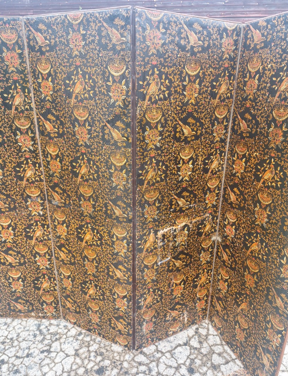 A late Victorian four-panel folding screen made of painted canvas featuring repeating golden bird and floral patterns on a dark black background. View IX