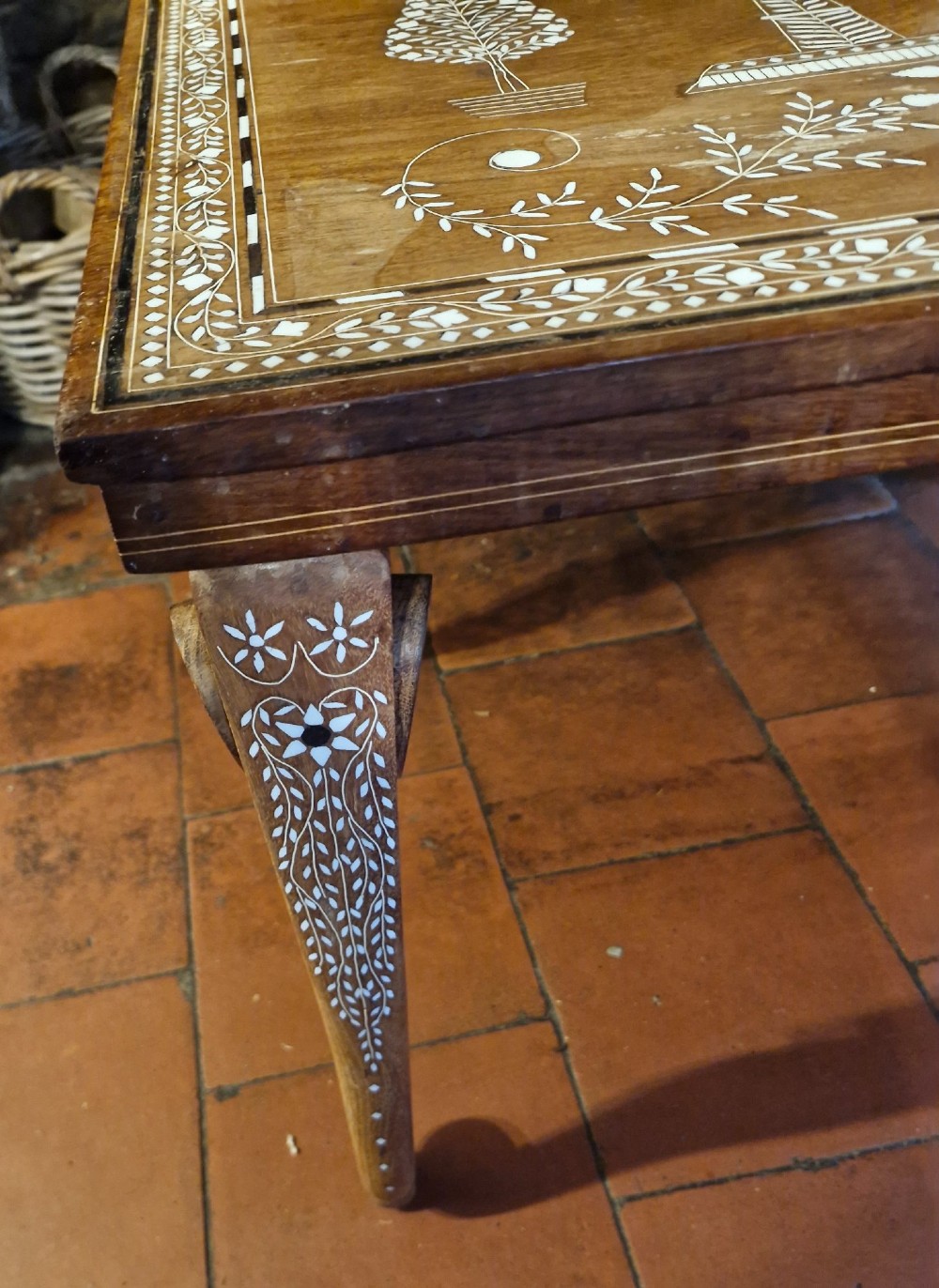 A rectangular warm brown hardwood table featuring detailed white bone inlay depicting the Taj Mahal surrounded by floral borders and curved inlaid legs. View III