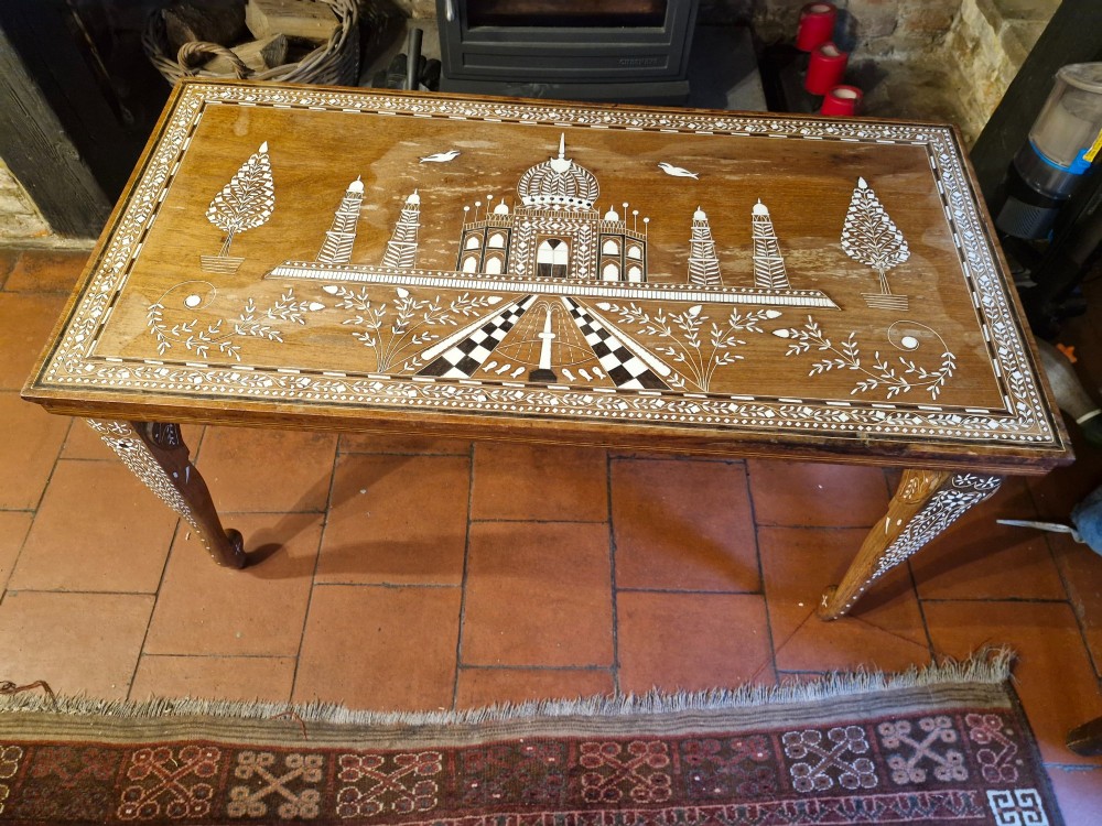 A rectangular warm brown hardwood table featuring detailed white bone inlay depicting the Taj Mahal surrounded by floral borders and curved inlaid legs. View VII
