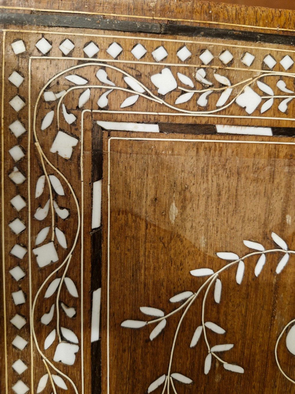A rectangular warm brown hardwood table featuring detailed white bone inlay depicting the Taj Mahal surrounded by floral borders and curved inlaid legs. View XI