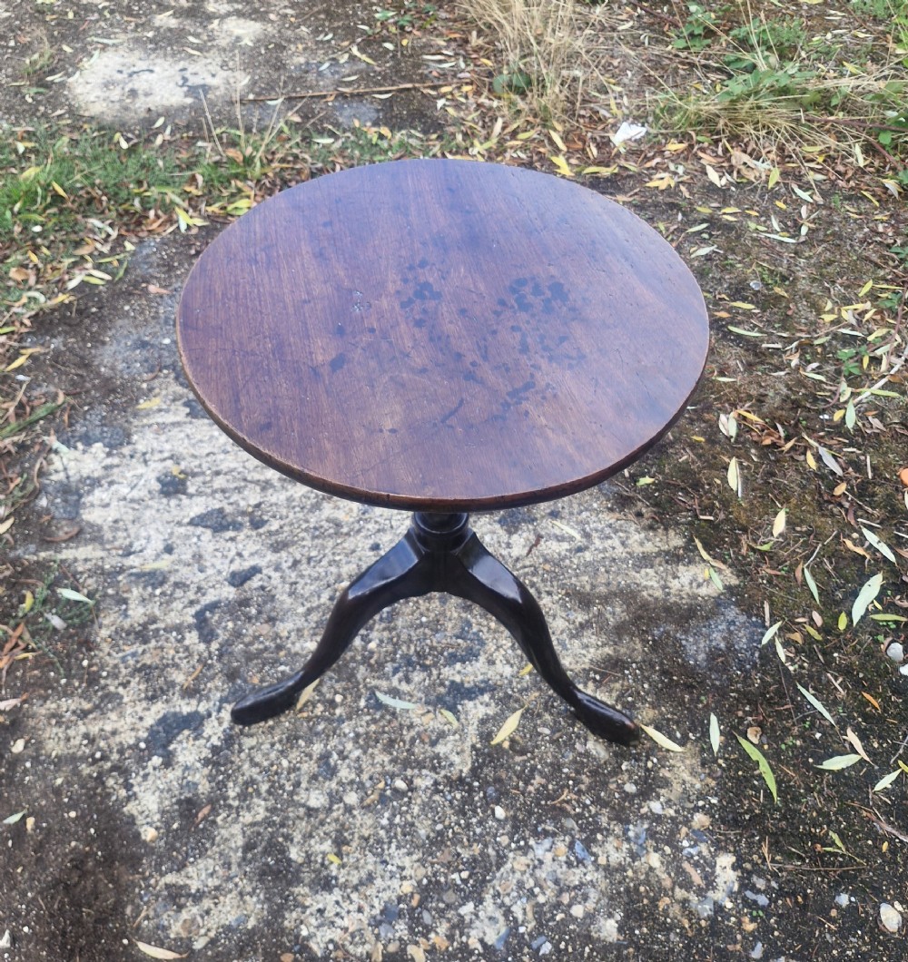 A Regency period mahogany occasional table featuring a circular top, turned central column stem, and three splayed legs. View V