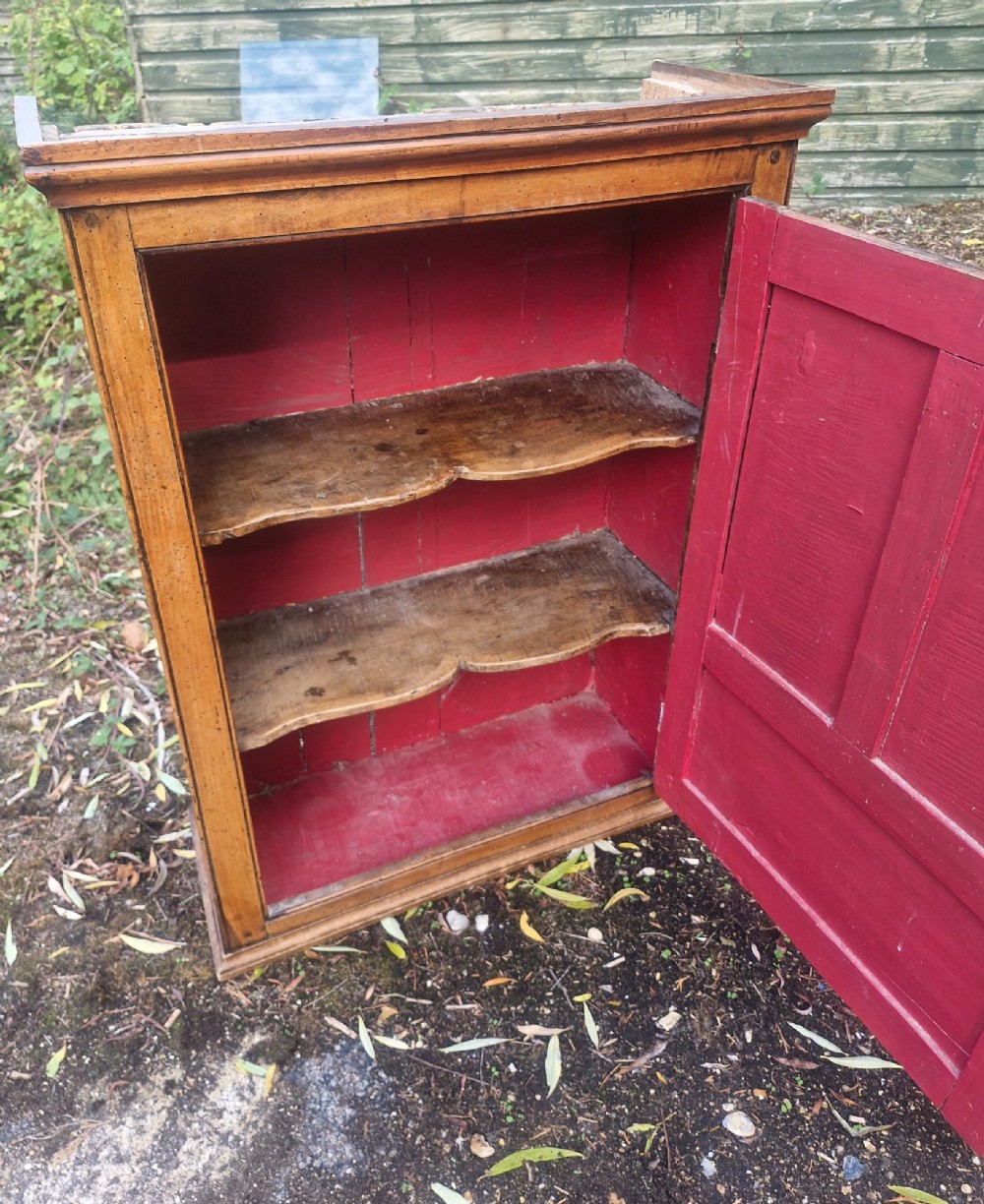 A Georgian timber wall cupboard featuring a panelled door with a turned handle and a brass keyhole. View II