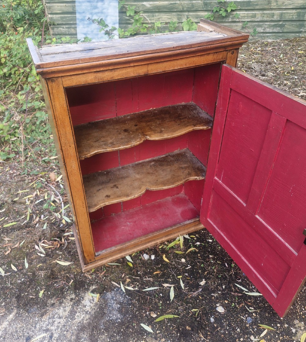 A Georgian timber wall cupboard featuring a panelled door with a turned handle and a brass keyhole. View V