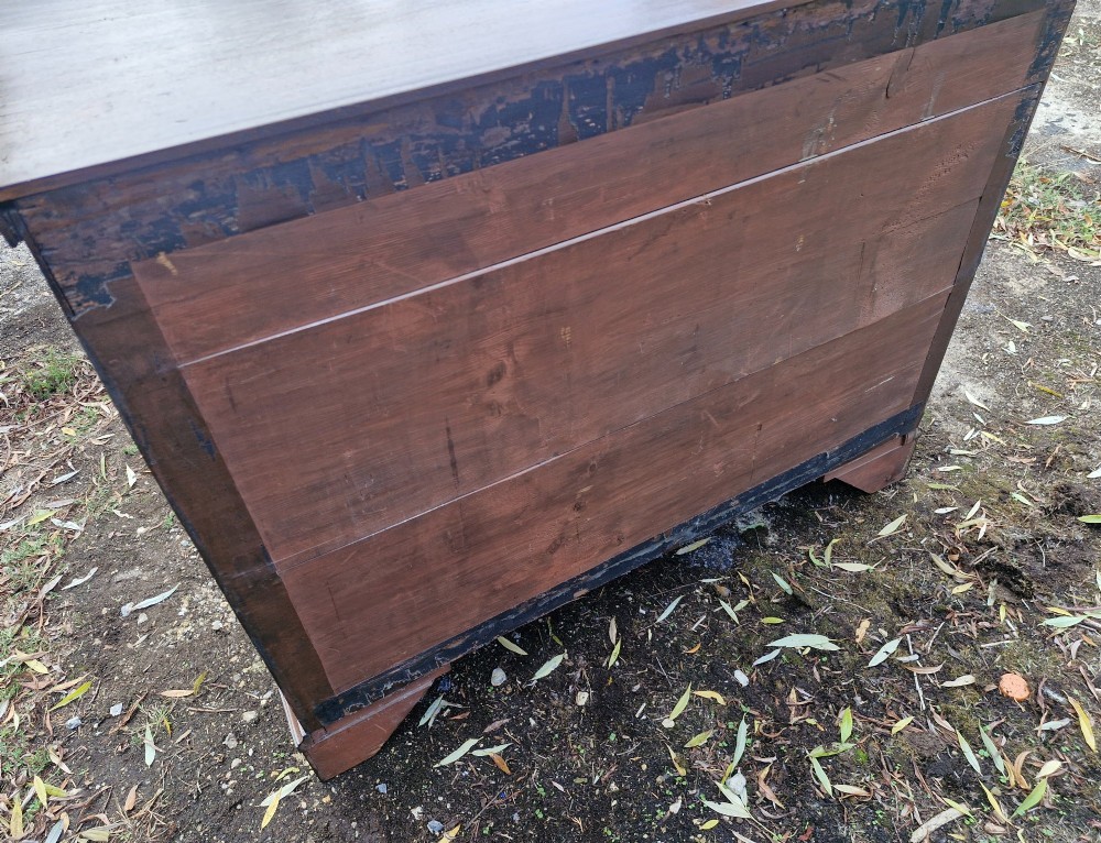 A Late Georgian mahogany chest of drawers featuring a two-over-three drawer configuration, fluted pilasters, bracket feet, and brass swan-neck handles. View II