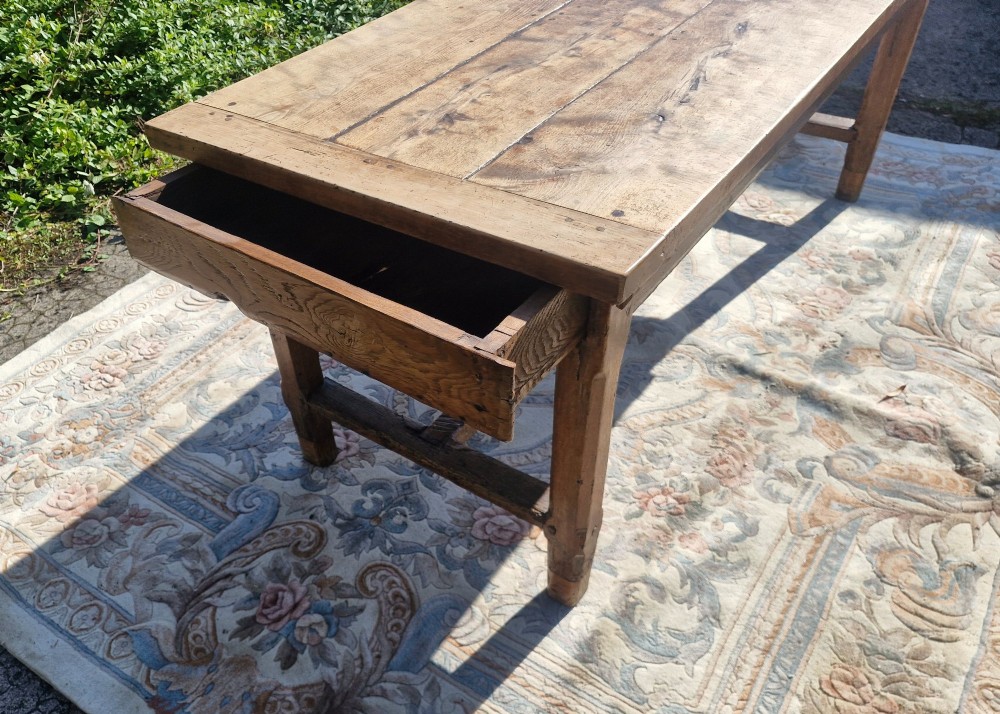 A rustic French farmhouse dining table made of weathered oak with a heavy plank top and sturdy stretcher base. View IV