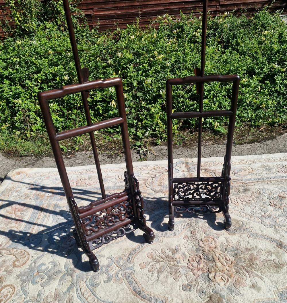 A pair of dark carved hardwood Chinese adjustable standard lamps featuring openwork bases and slender vertical shafts. View III