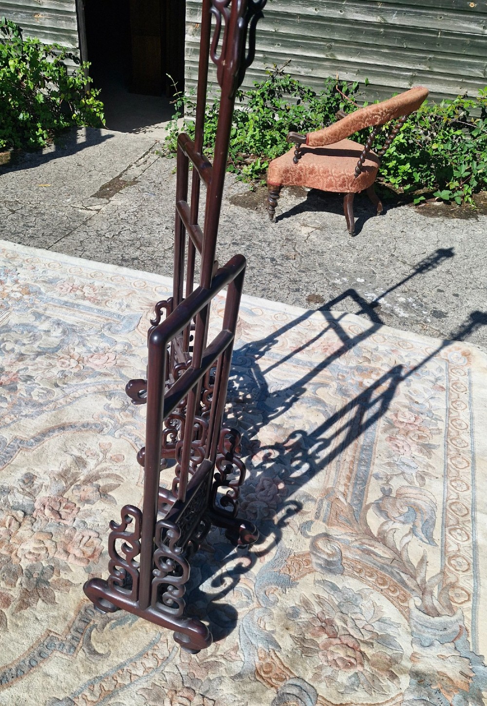 A pair of dark carved hardwood Chinese adjustable standard lamps featuring openwork bases and slender vertical shafts. View IV