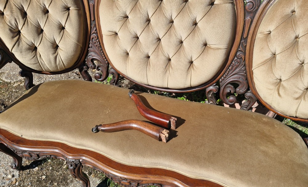 A 19th-century mahogany conversation sofa featuring three oval button-back upholstered panels, intricate carved frame detailing, cabriole legs, and velvet seating. View VII