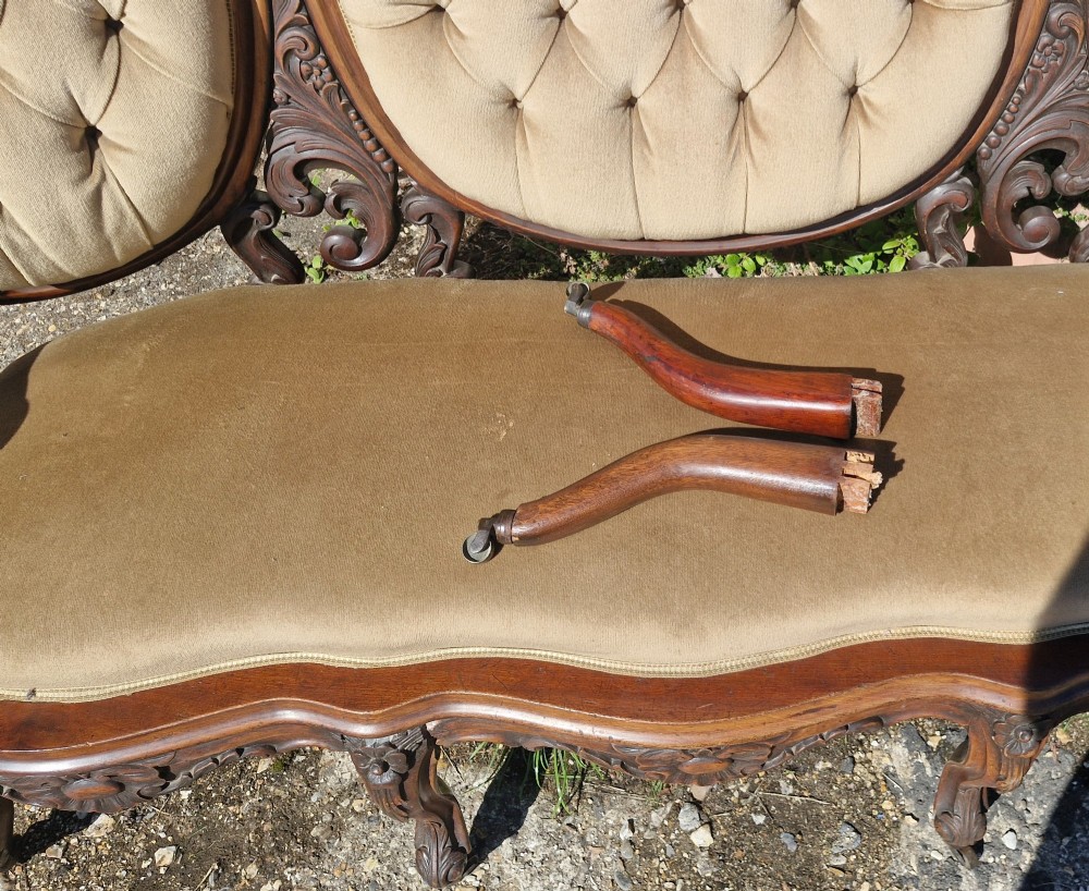 A 19th-century mahogany conversation sofa featuring three oval button-back upholstered panels, intricate carved frame detailing, cabriole legs, and velvet seating. View VIII