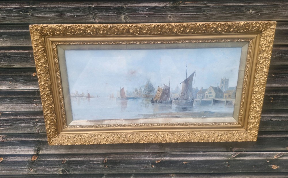 A wide horizontal oil painting depicting sailing barges on the River Thames, enclosed within an ornate gilded frame. View II