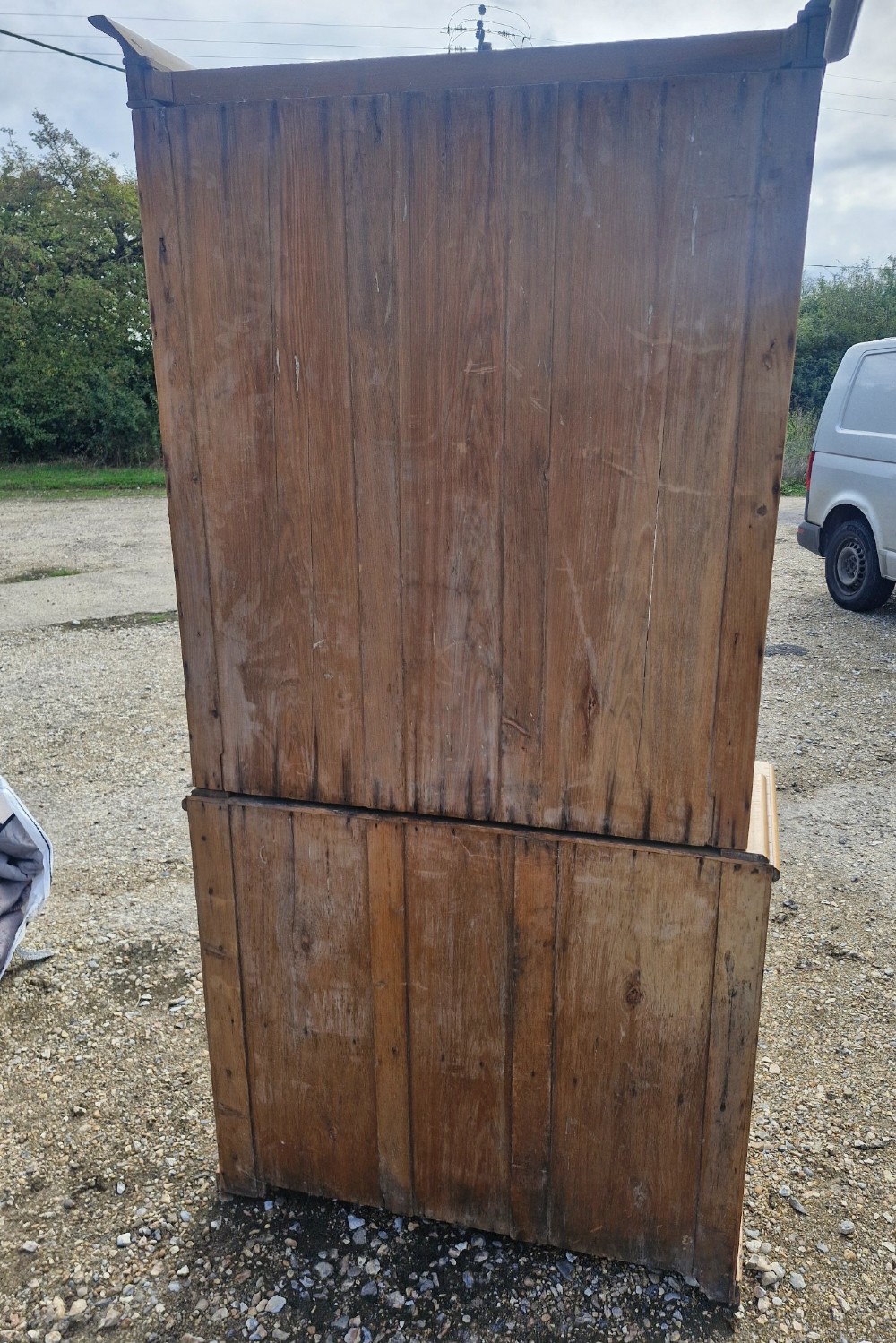 An early Victorian pine glazed bookcase featuring arched glass upper doors above a lower two-door cupboard base. View IV