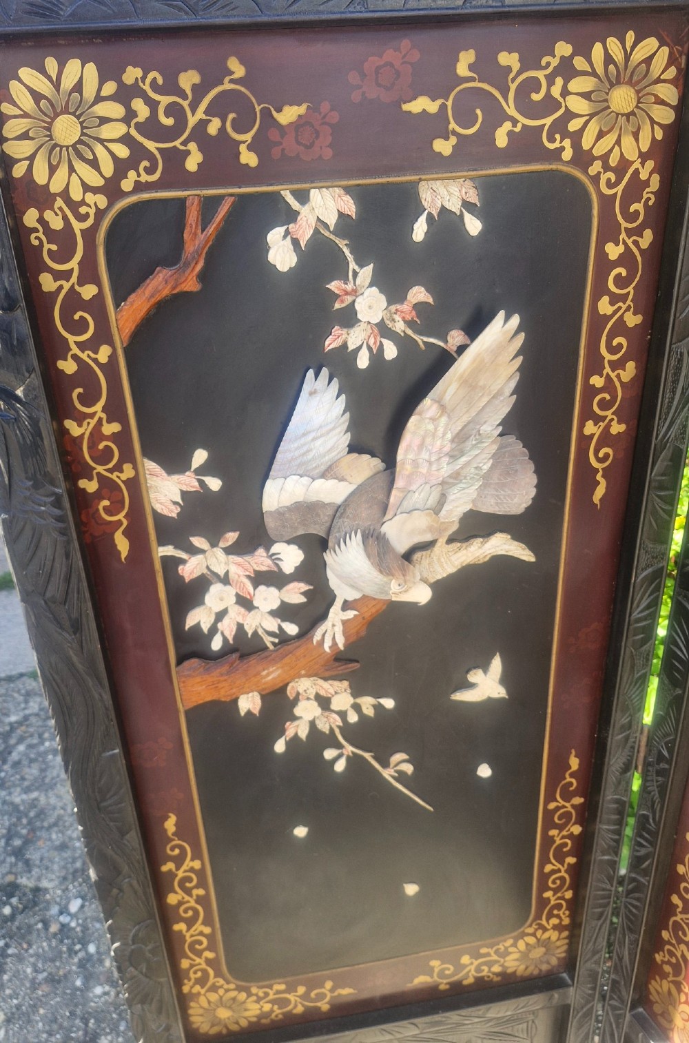 A four-panel dark wood folding screen featuring carved openwork top crests and central dark panels with raised bone inlays depicting birds among flowering branches. View II