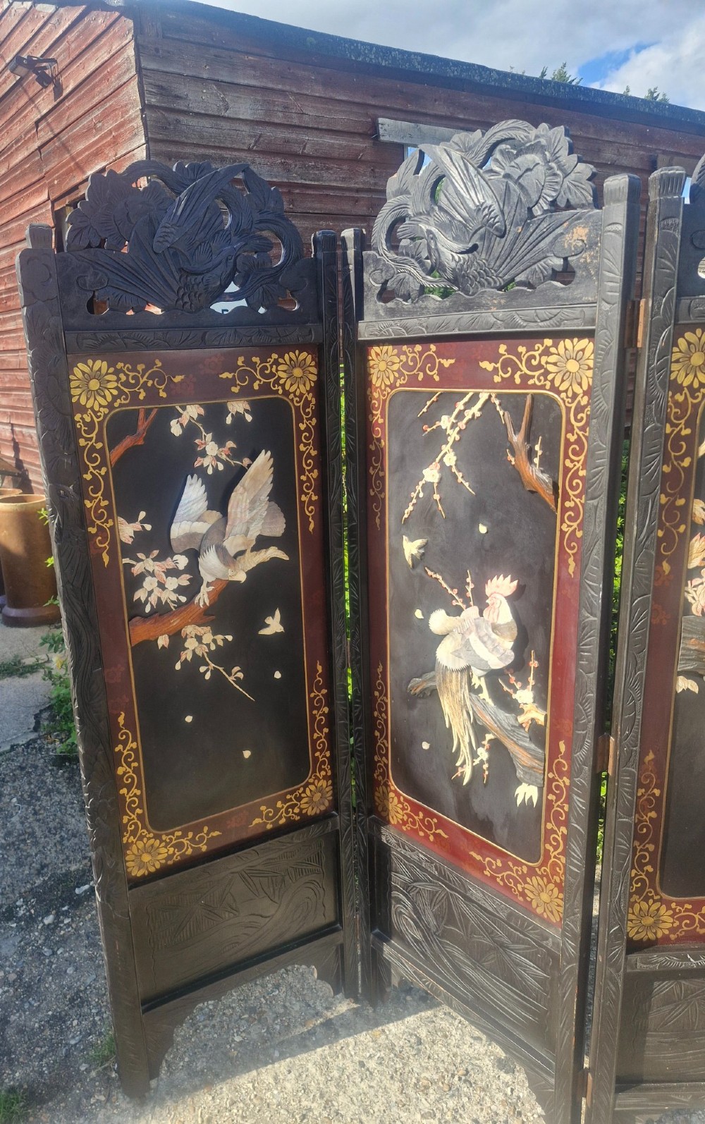 A four-panel dark wood folding screen featuring carved openwork top crests and central dark panels with raised bone inlays depicting birds among flowering branches. View XI