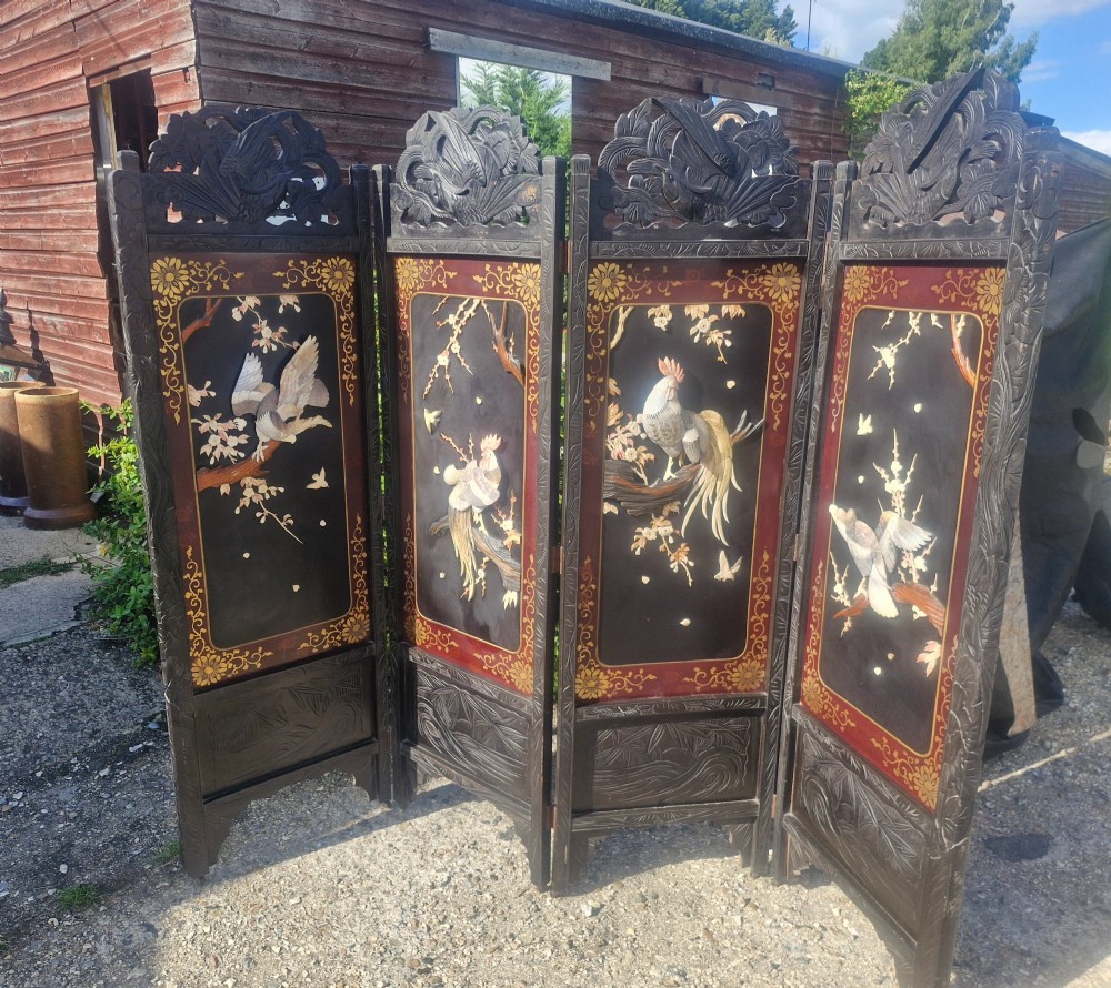 A four-panel dark wood folding screen featuring carved openwork top crests and central dark panels with raised bone inlays depicting birds among flowering branches. View XII
