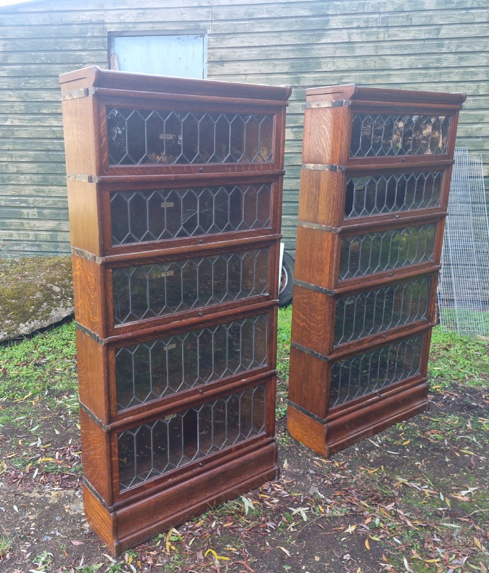 A pair of matching five-tier oak Globe Wernicke sectional bookcases featuring leaded glazed lift-up glass doors. View III