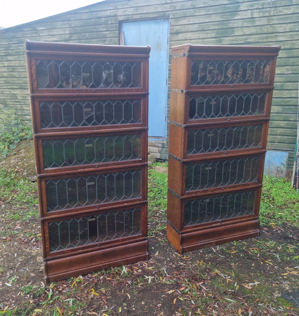 A pair of matching five-tier oak Globe Wernicke sectional bookcases featuring leaded glazed lift-up glass doors. View VII