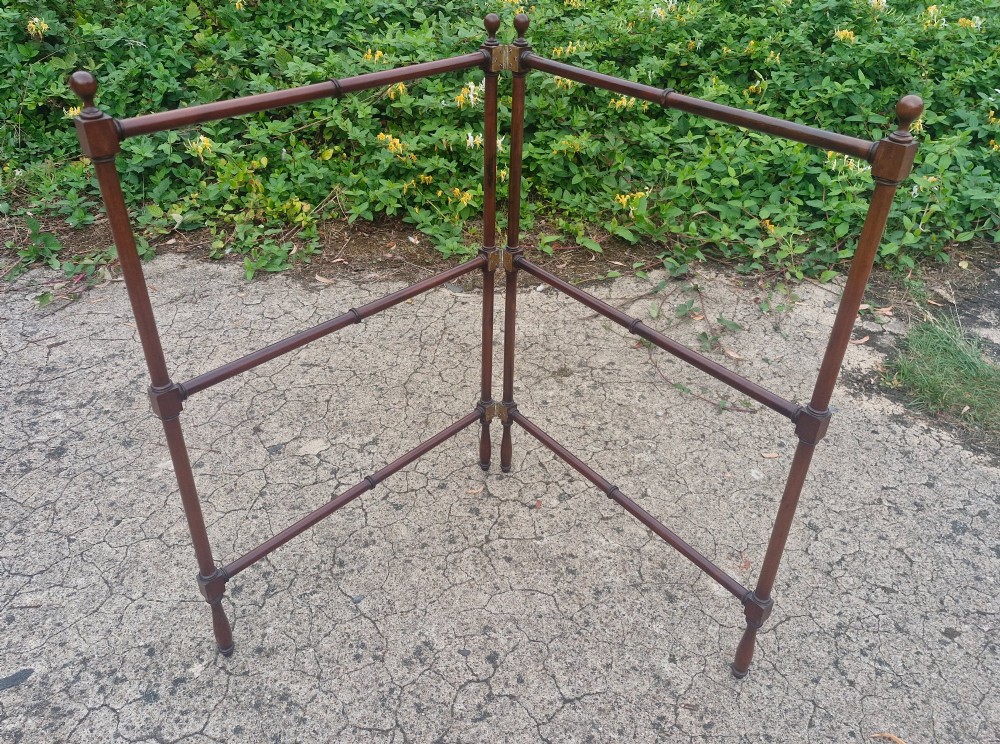 A freestanding mahogany folding towel rail with turned wooden finials and multiple horizontal crossbars on hinged upright supports. View IV