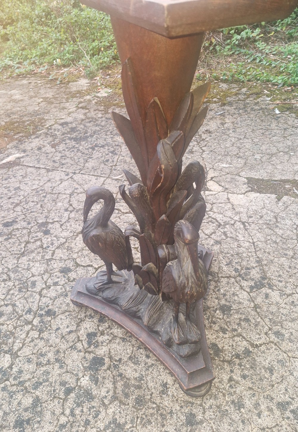 A Victorian carved oak occasional table featuring sculpted wading birds encircling a central pedestal above a triform base. View VI