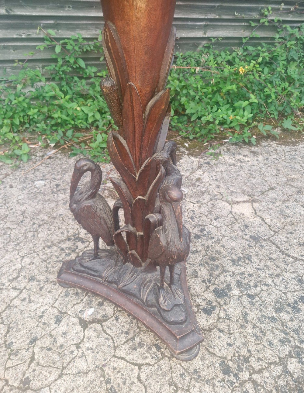 A Victorian carved oak occasional table featuring sculpted wading birds encircling a central pedestal above a triform base. View VIII