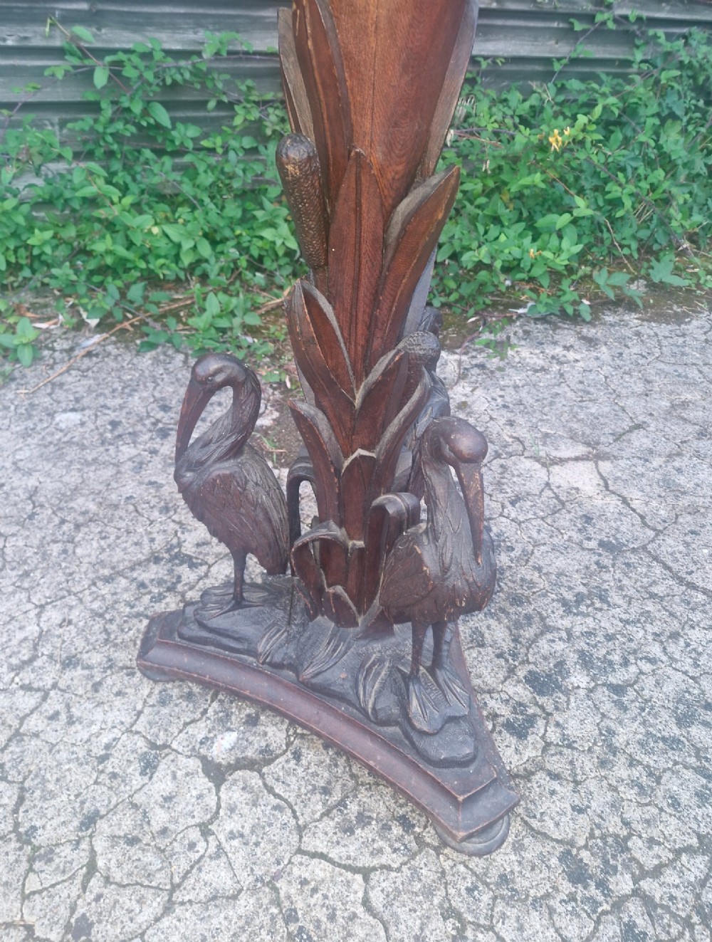A Victorian carved oak occasional table featuring sculpted wading birds encircling a central pedestal above a triform base. View IX