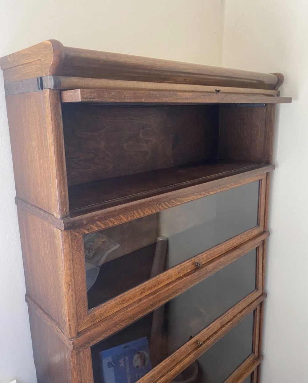 A five-tier Edwardian oak Globe Wernicke stacking bookcase featuring lift-up glazed doors and a base drawer. View II