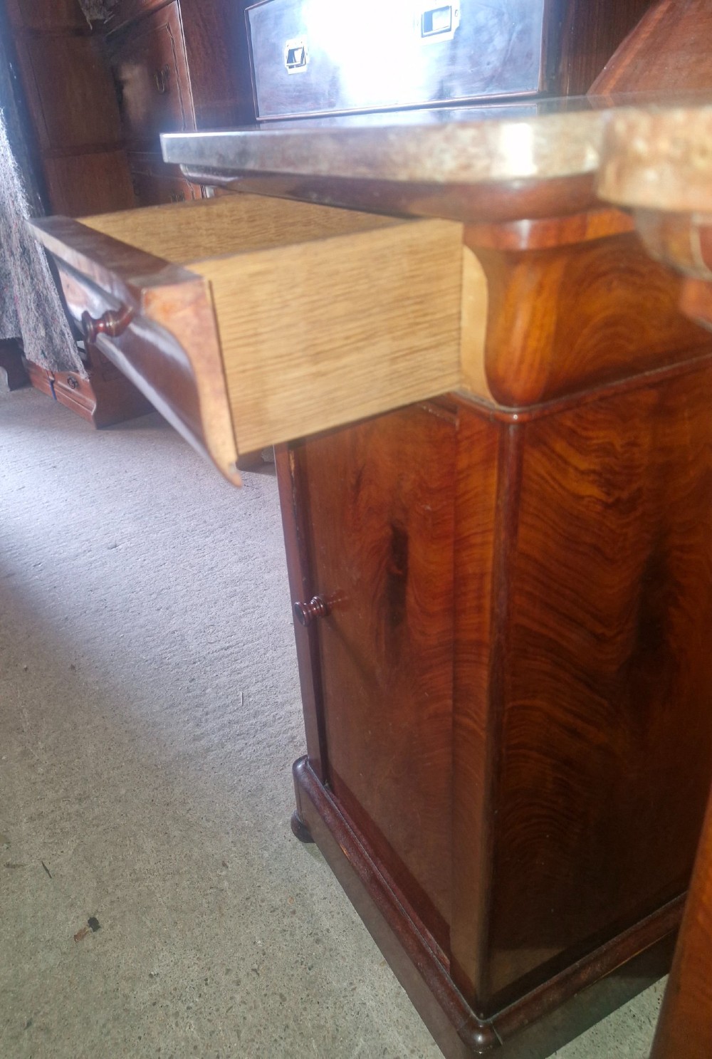 A pair of French mahogany bedside cabinets with reddish brown marble tops, upper drawers, and single panelled doors. View III