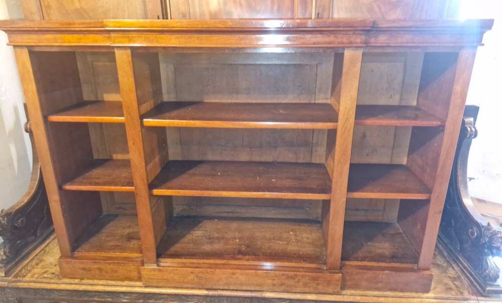 A mid-19th-century mahogany open-front bookcase featuring a three-bay breakfront design and adjustable shelves set on a solid plinth base. View II