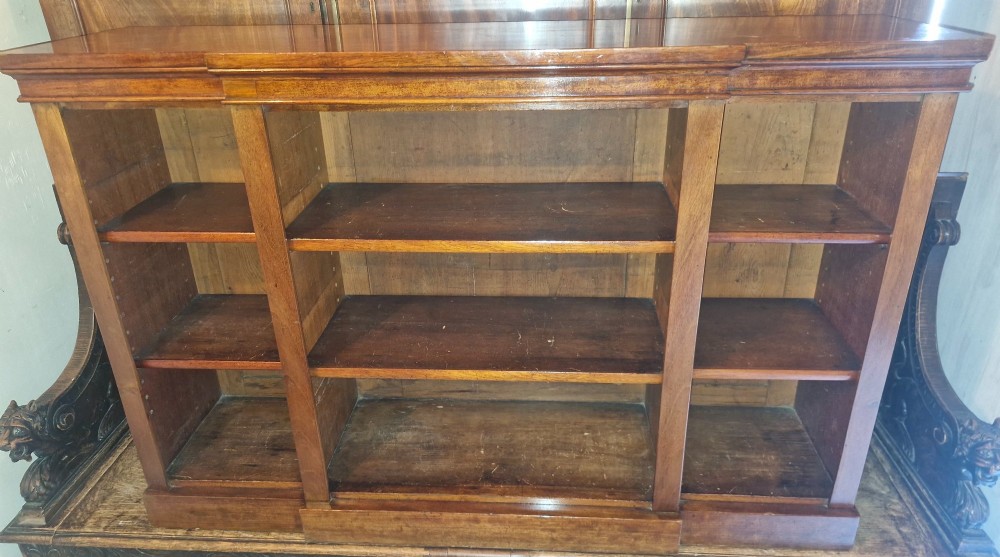 A mid-19th-century mahogany open-front bookcase featuring a three-bay breakfront design and adjustable shelves set on a solid plinth base. View VII