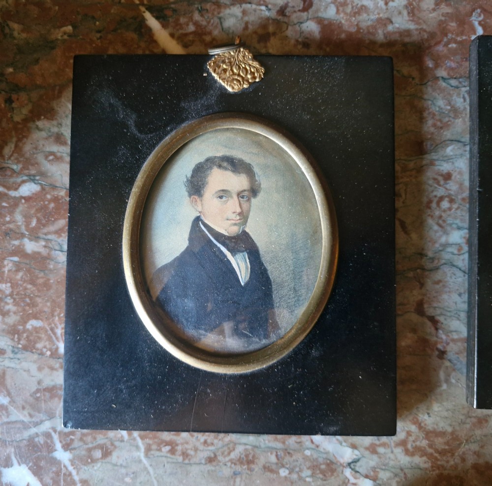 A set of five 19th-century antique portrait miniatures painted on papercard, displayed in dark ebonised frames with brass bezel rims. View III