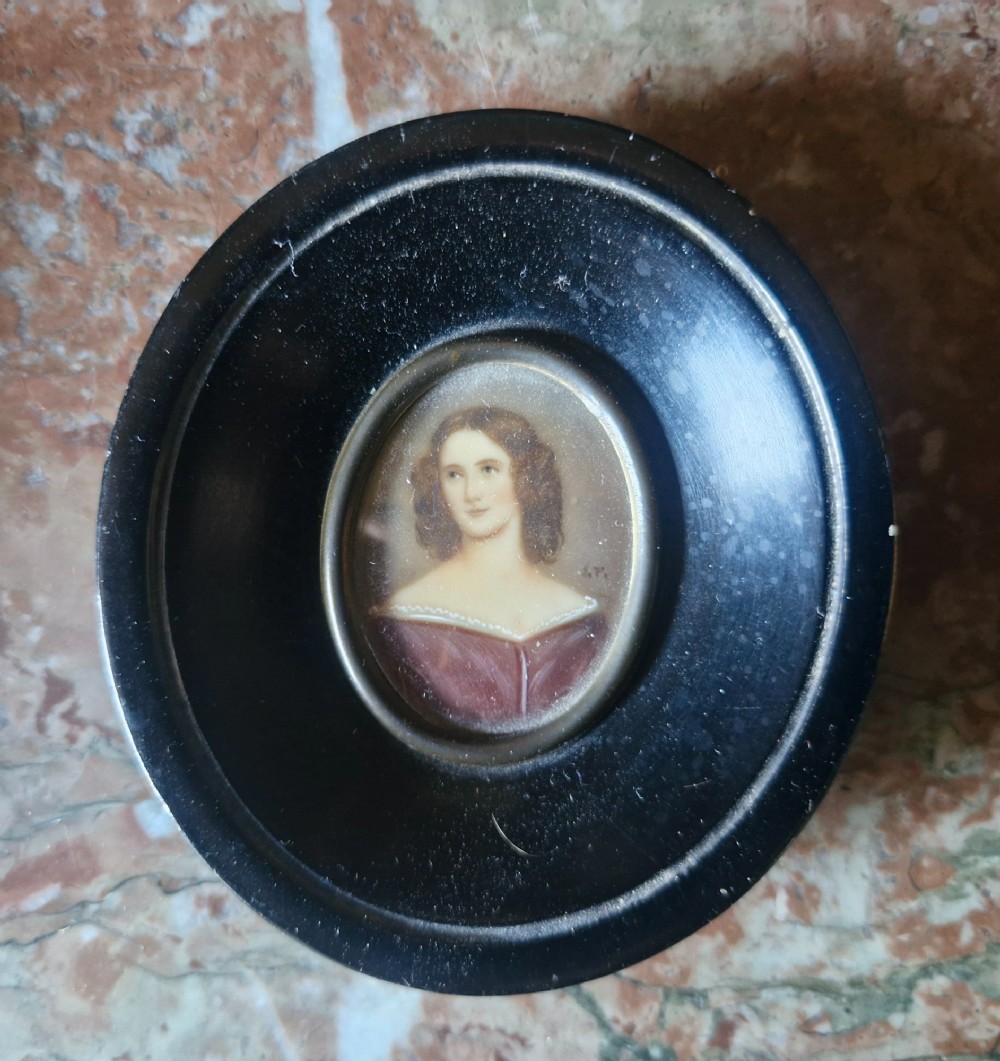 A set of five 19th-century antique portrait miniatures painted on papercard, displayed in dark ebonised frames with brass bezel rims. View VI