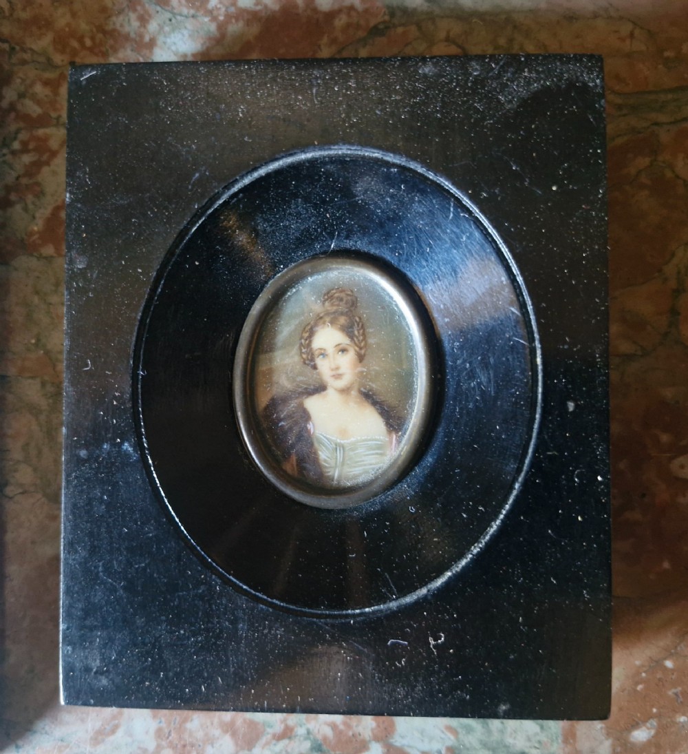 A set of five 19th-century antique portrait miniatures painted on papercard, displayed in dark ebonised frames with brass bezel rims. View VII