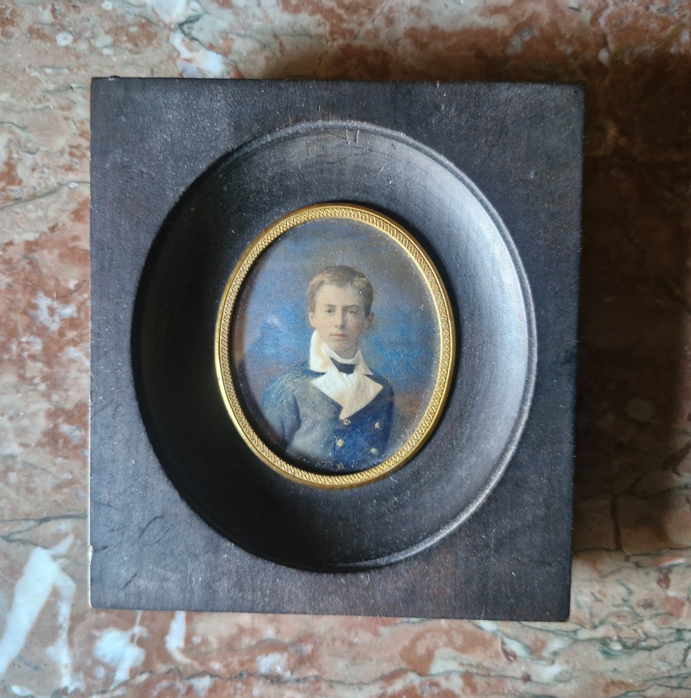 A set of five 19th-century antique portrait miniatures painted on papercard, displayed in dark ebonised frames with brass bezel rims. View VIII