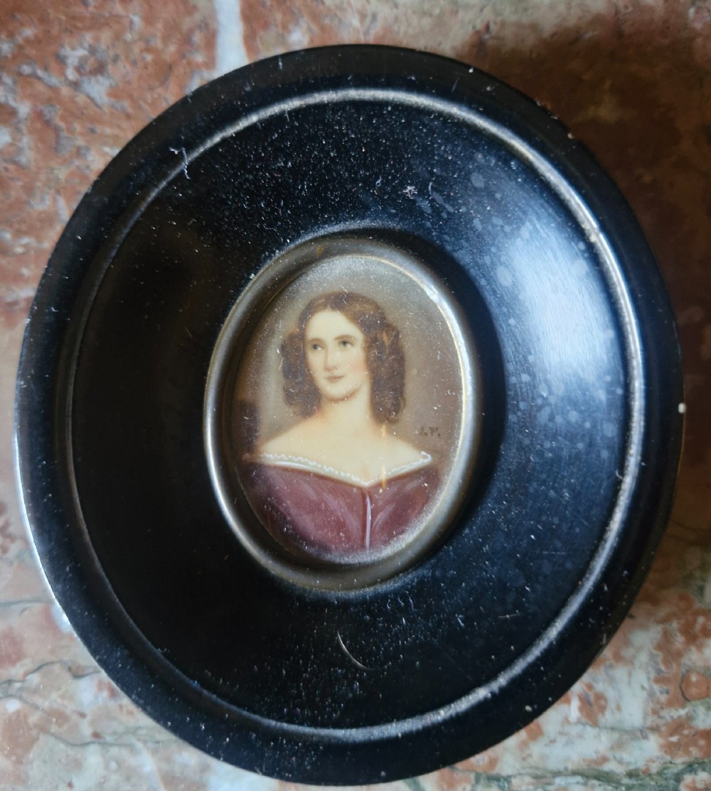 A set of five 19th-century antique portrait miniatures painted on papercard, displayed in dark ebonised frames with brass bezel rims. View IX