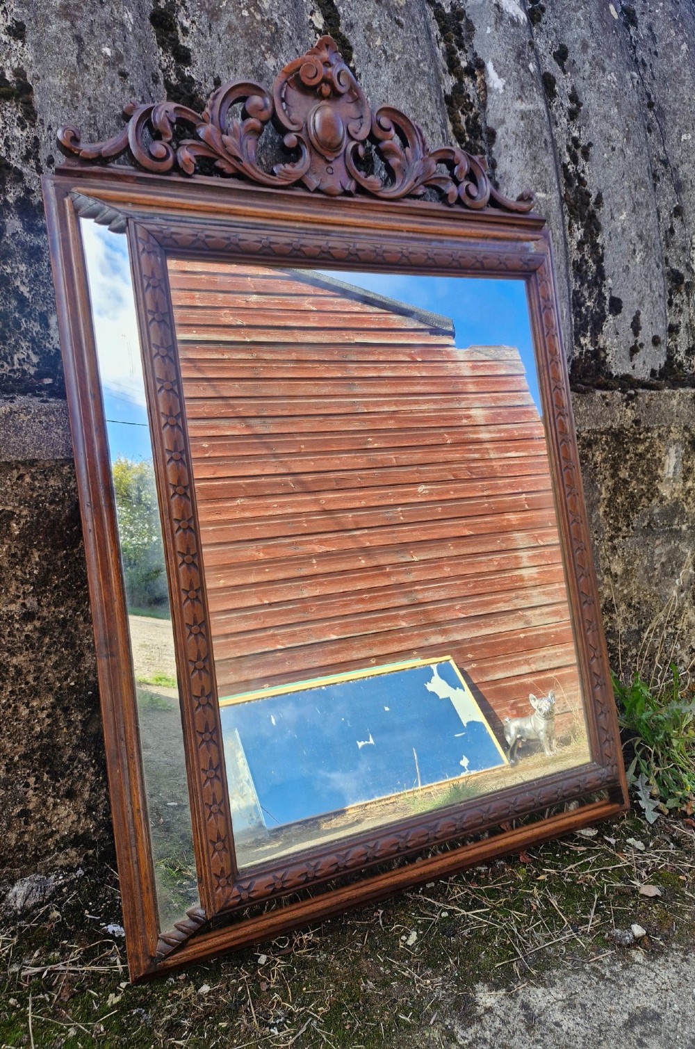 A rectangular French oak wall mirror featuring a bevelled glass plate and a pierced carved cresting with scroll motifs. View III