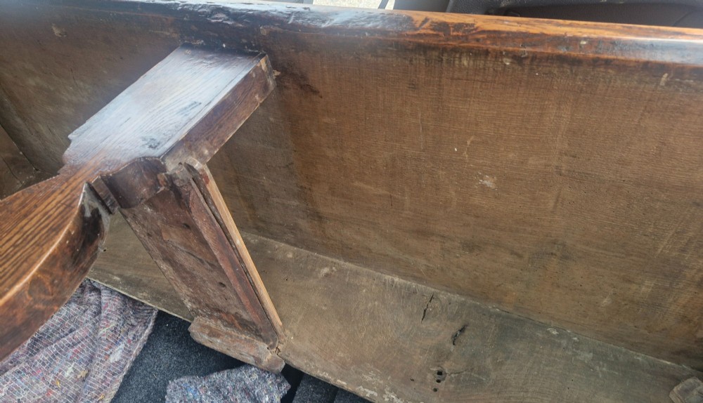 An early 19th-century country oak serving table featuring a long rectangular top, two drawers with brass teardrop handles, and shaped flat-profile legs. View II