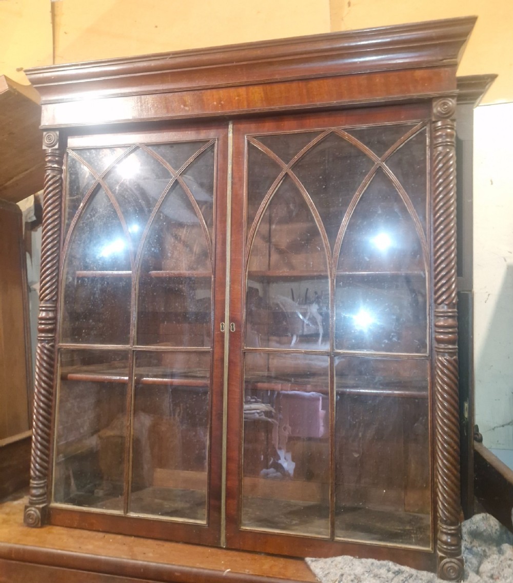 A Regency mahogany wall cabinet featuring two Gothic astragal glazed doors, spiral-turned side columns, and carved roundel corner details. View III