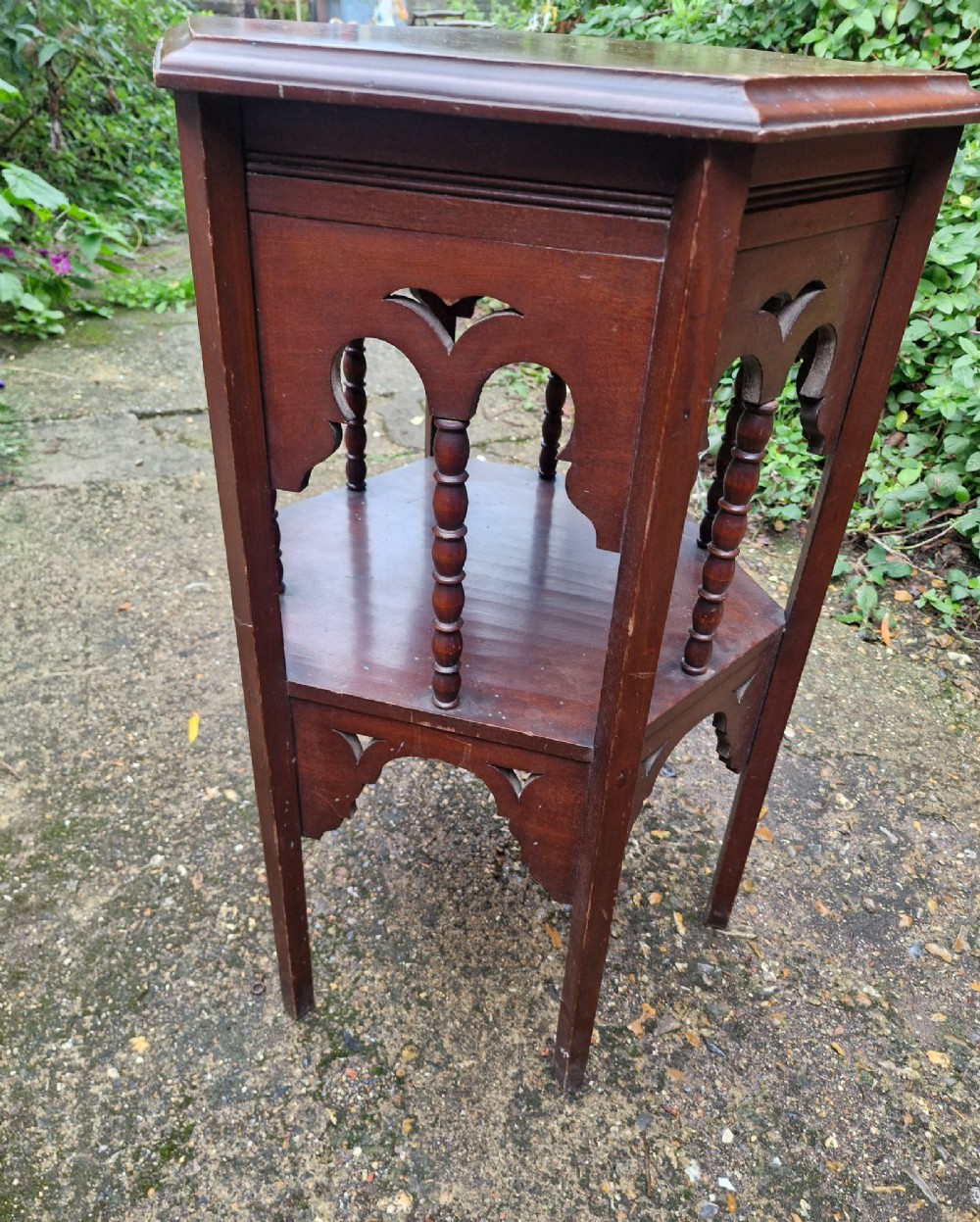 A dark mahogany hexagonal occasional table featuring a lower shelf, turned spindle supports, and cut-out decorative aprons. View II