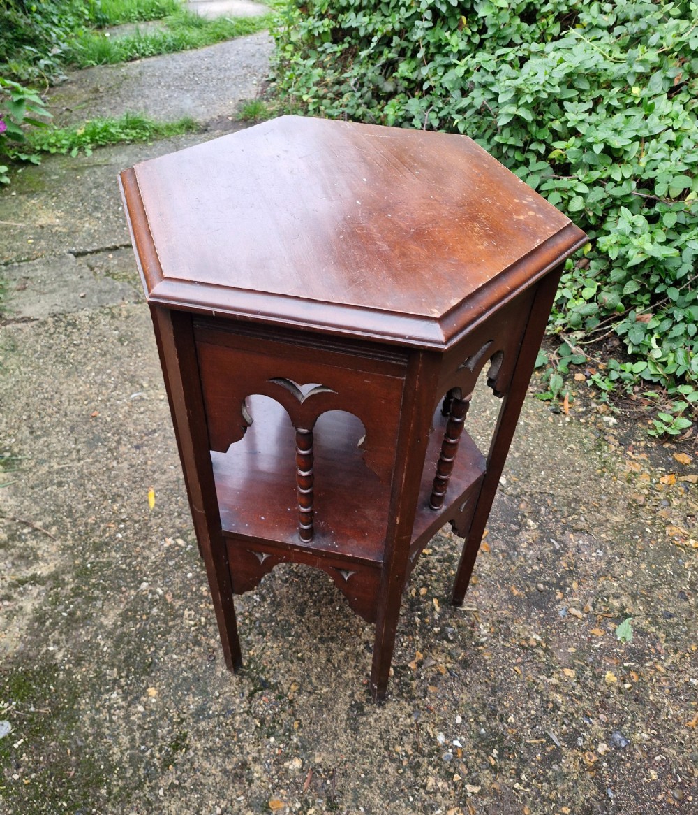 A dark mahogany hexagonal occasional table featuring a lower shelf, turned spindle supports, and cut-out decorative aprons. View IV