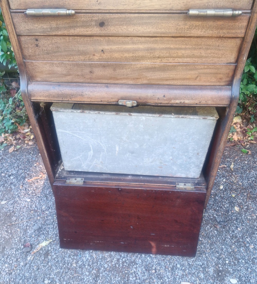 An Edwardian wooden ships washstand featuring an upper arched mirror, a middle drop-front door revealing a white ceramic washbasin, and lower cupboard doors. View X