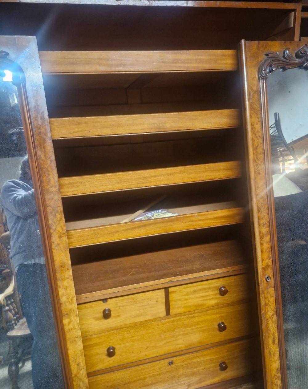 A large Victorian breakfront wardrobe crafted from highly figured burr walnut with two central mirrored doors and carved scrollwork details. View VII