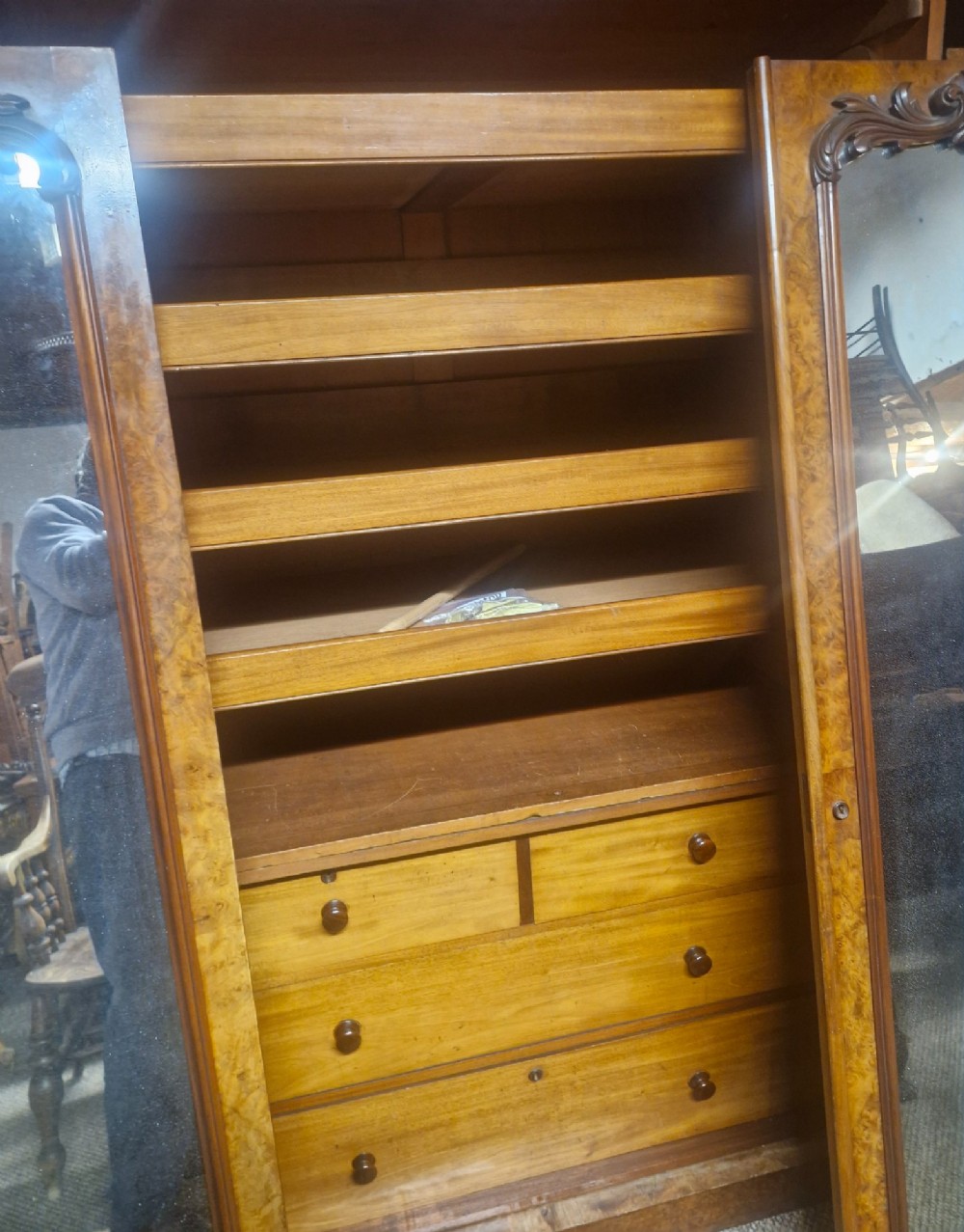 A large Victorian breakfront wardrobe crafted from highly figured burr walnut with two central mirrored doors and carved scrollwork details. View VIII