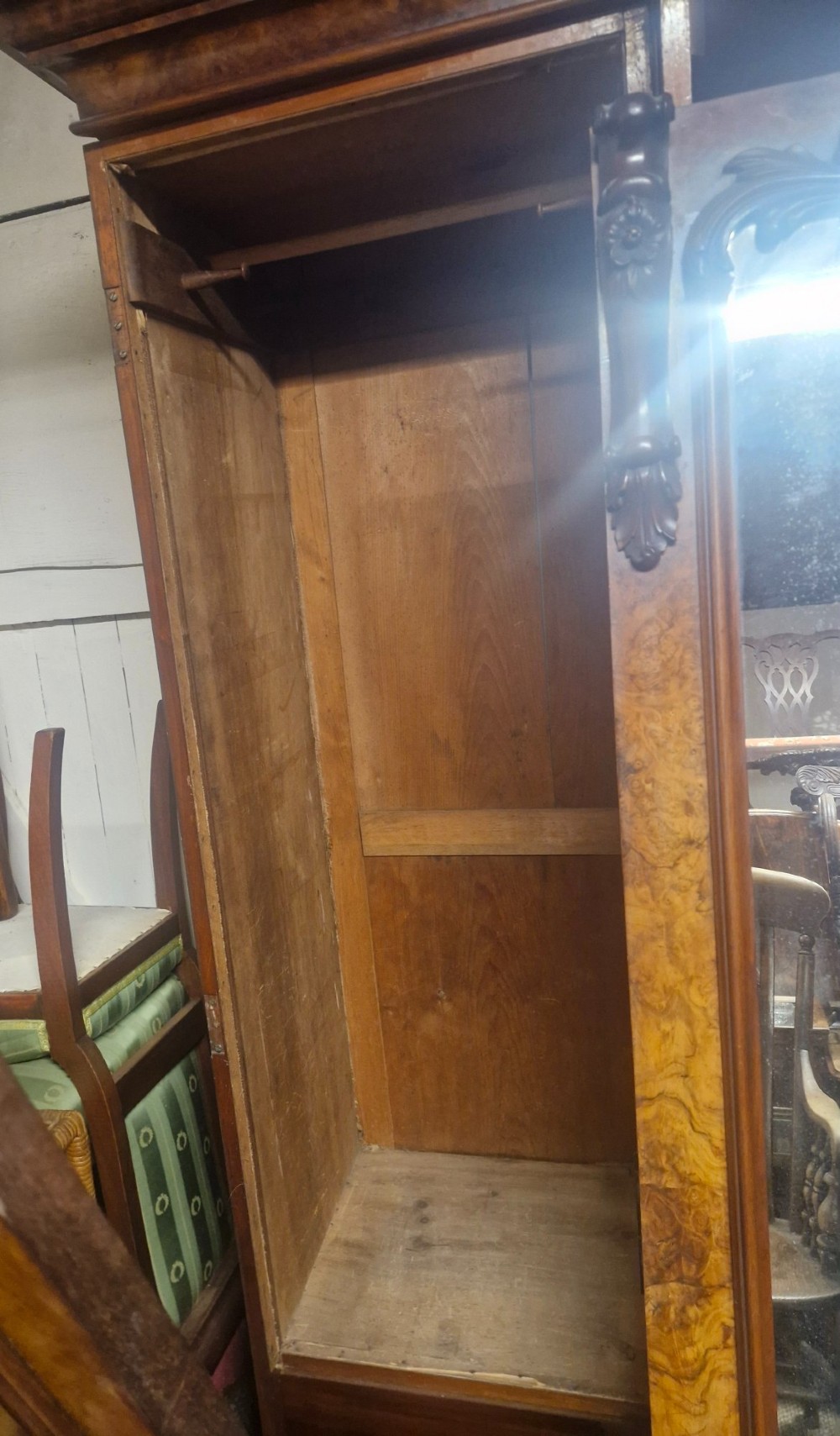 A large Victorian breakfront wardrobe crafted from highly figured burr walnut with two central mirrored doors and carved scrollwork details. View X