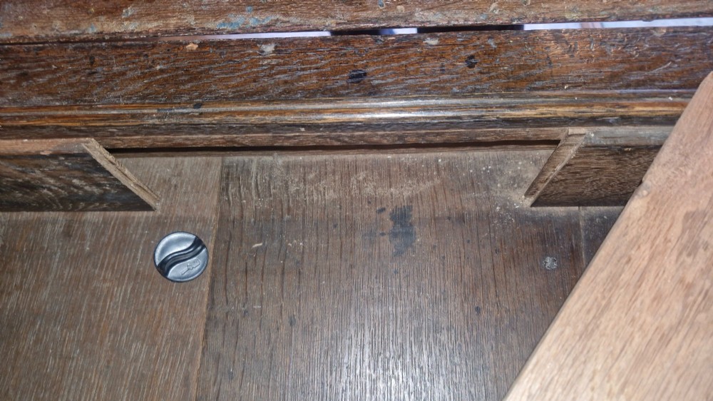 An antique oak bureau bookcase featuring a two-door glazed upper section, a slant-front writing desk, candle slides, and lower drawers raised on bun feet. View V