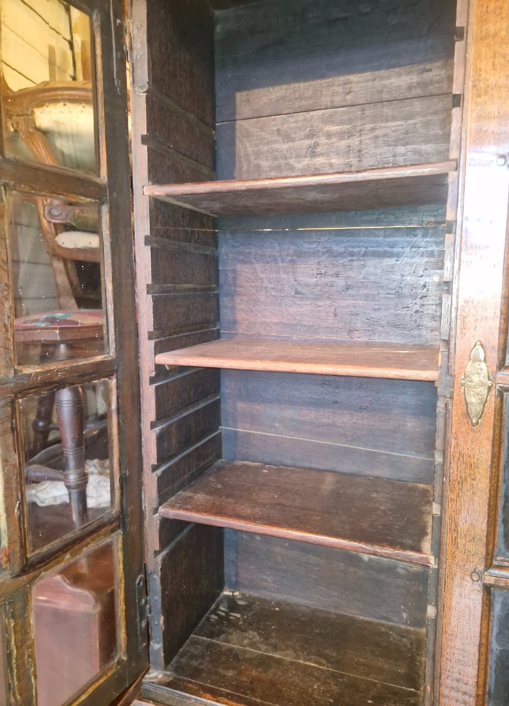 An antique oak bureau bookcase featuring a two-door glazed upper section, a slant-front writing desk, candle slides, and lower drawers raised on bun feet. View XIII