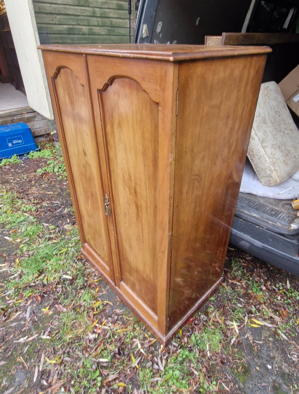 An open twin-door mahogany valet cupboard revealing an internal trouser press mechanism with brass turn-screws and integrated hanging racks. View IV