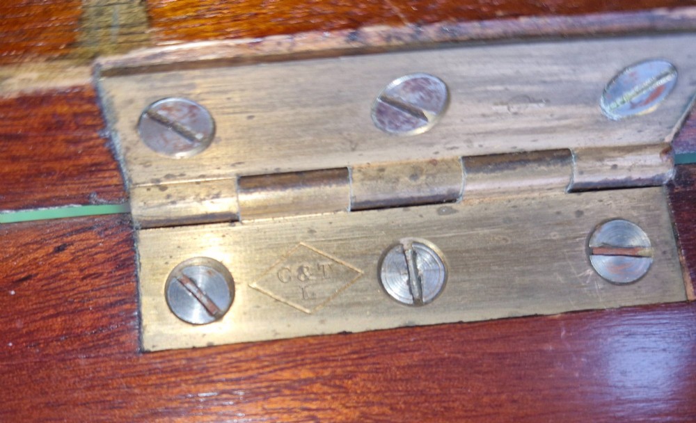 An open twin-door mahogany valet cupboard revealing an internal trouser press mechanism with brass turn-screws and integrated hanging racks. View XV