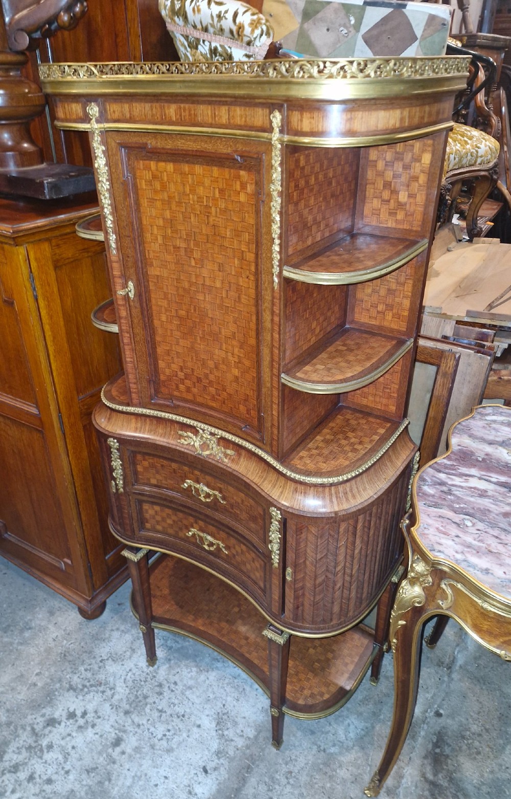 A French Louis XVI style tiered side cabinet crafted with checkerboard parquetry wood veneer, brass gallery, and ornamental ormolu mounts. View XIV